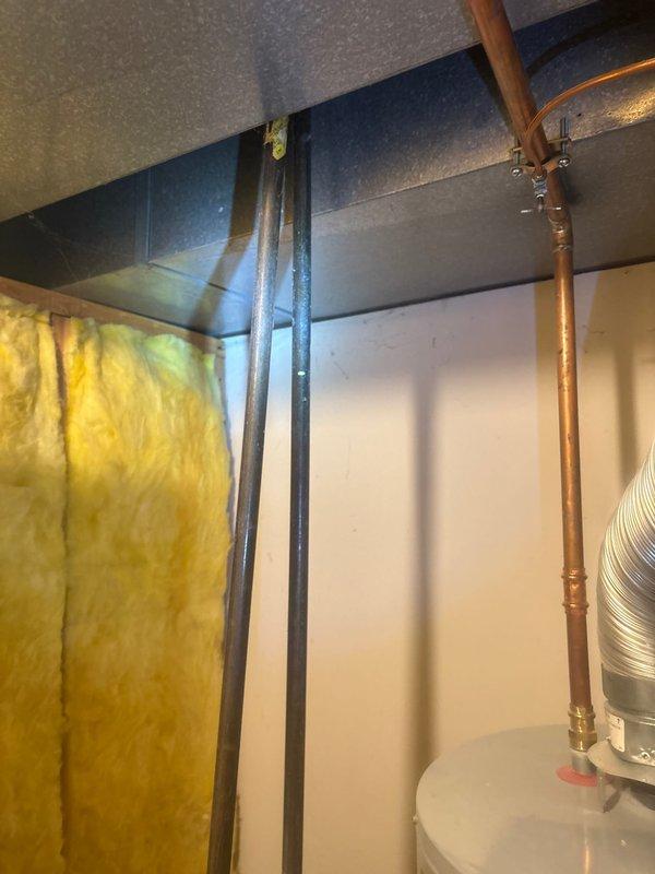 Performed water leak detection service in response to customer's report of substantially increased water bills as flagged by local water department. Conducted thorough inspection of utility room containing water heater installation, paying particular attention to visible copper plumbing lines and connections. Examined areas with exposed fiberglass insulation for signs of moisture or water damage to identify potential leak source.