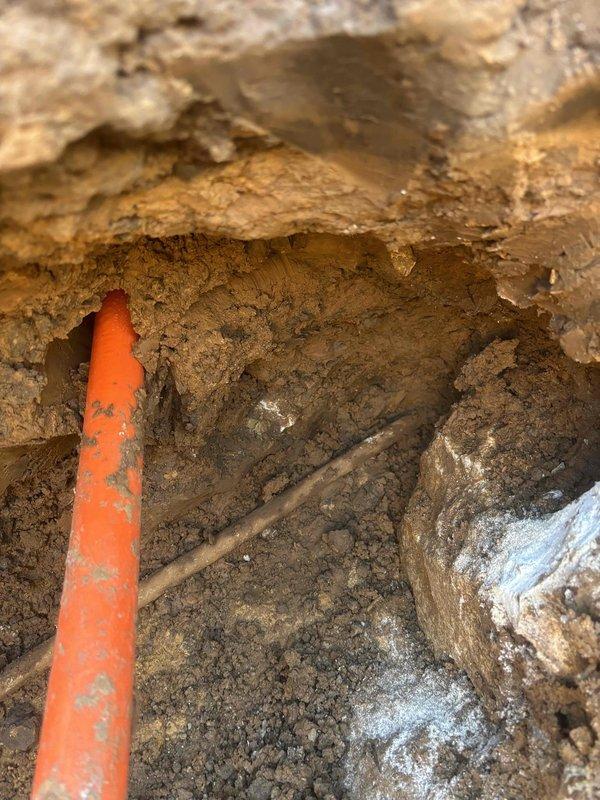 Excavated access to main water line to address significantly reduced water pressure that occurred following fiber optic installation in the neighborhood. Hand-digging was necessary due to numerous underground utilities and pipes in the repair area. Successfully repaired the compromised water main, restored full water pressure throughout the residence, and backfilled the excavation site.