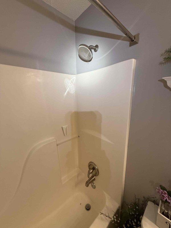 Installed customer-supplied shower valve with associated copper piping connections in bathroom. Created two access panels for future maintenance accessibility. Completed full installation with proper water connections and verified functionality of new shower/tub fixture assembly.