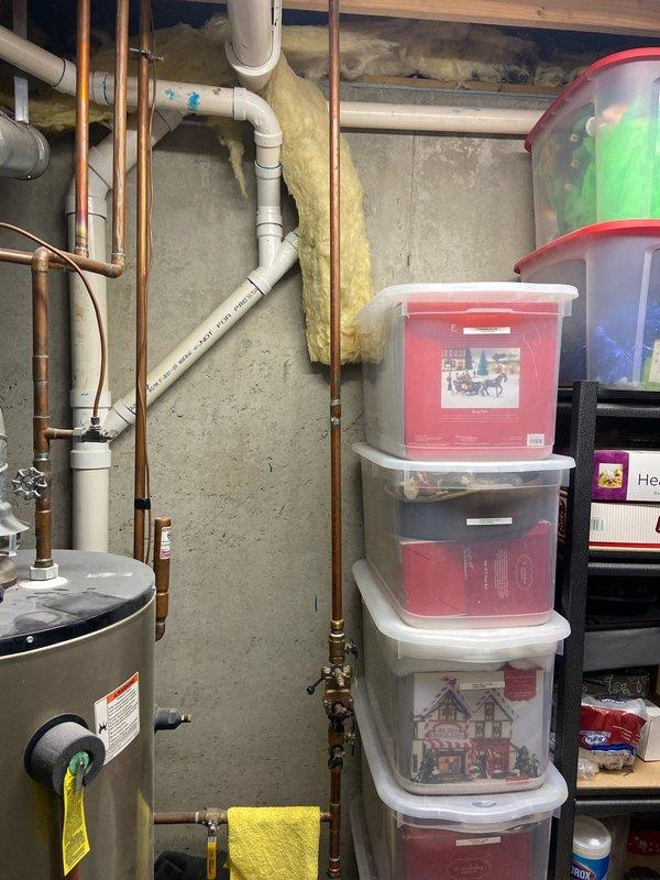 Conducted follow-up assessment for potential tankless water heater installation. Evaluated existing mechanical room containing current tank-style water heater, HVAC system with flexible ductwork, and associated copper/PVC plumbing. Documented current setup and space constraints to provide homeowner with appropriate recommendations for dual tankless water heater conversion.