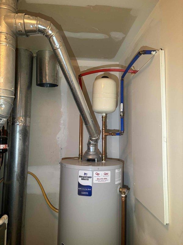 Conducted comprehensive plumbing system maintenance inspection with focus on Bradford White water heater system and associated components. Examined tank, expansion tank, ventilation duct, copper pipes, brass fittings, and PEX piping, confirming all connections are secure with no signs of leaks, corrosion, or damage. Also inspected adjacent HVAC unit with electrical connections and ventilation components, all systems functioning properly with no issues identified.