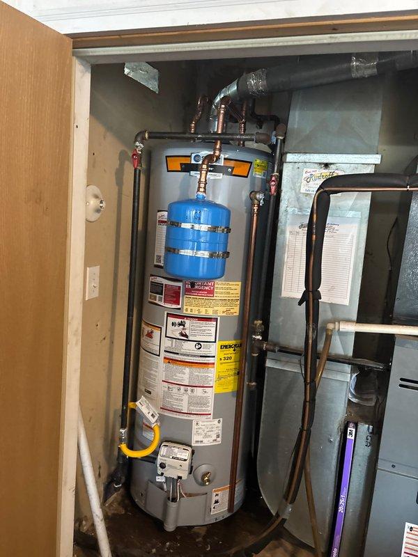 Successfully installed a new 40-gallon Rheem Platinum gas water heater with thermal expansion tank in utility room. Completed all necessary copper pipe connections, installed proper gas line connection, and verified system operation. Equipment was properly mounted and all safety features were confirmed functional.