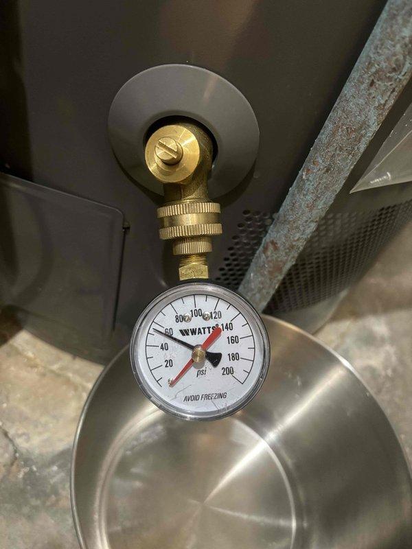 Inspected water heater pressure relief valve leakage issue on Rheem Performance Platinum unit installed in 2022. Found system pressure reading approximately 130-140 psi (well above normal range), with visible corrosion on copper piping. Replaced defective pressure relief valve and adjusted water pressure to manufacturer specifications to resolve the leak.