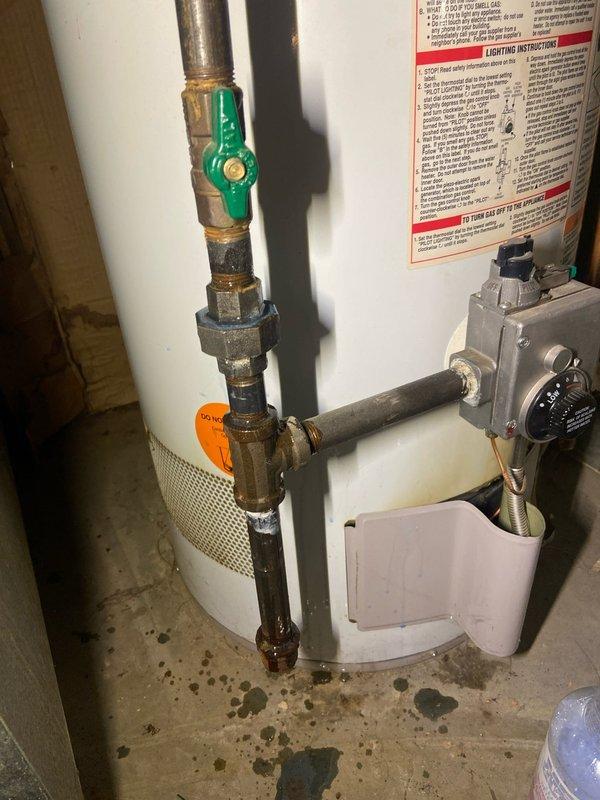 Performed service on tanked water heater in basement. Removed safety tag, verified proper operation, and relit the unit. Conducted gas leak test using bubble solution with no leaks detected. Confirmed carbon monoxide alarm was properly installed and functioning.