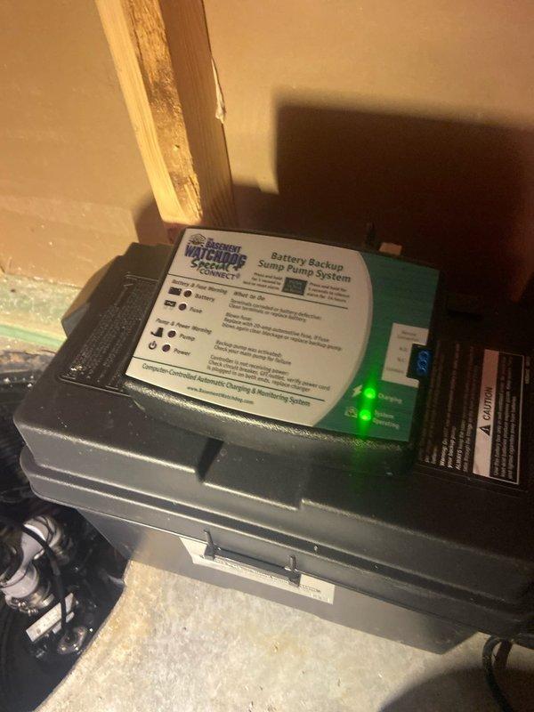 Responded to service call for a non-functioning Basement Watchdog Special Connect battery backup sump pump system that was making a continuous buzzing noise. Upon inspection, found the pump was operational with proper power connection as indicated by the illuminated green LED on the control panel. Verified proper installation of the discharge pipe and pump mechanism within the sump basin, confirming system is now functioning correctly.