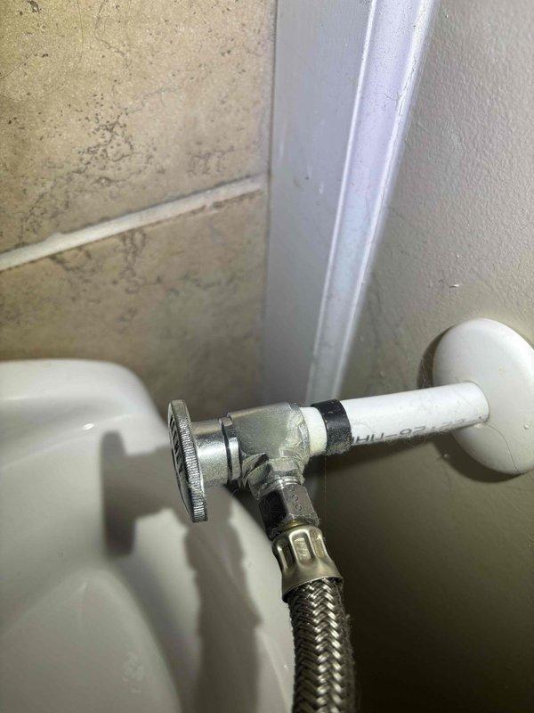 Responded to service call for toilet leaking at base in primary bathroom. Inspected water supply line connection and valve assembly, noting minor corrosion. Measured toilet positioning, replaced worn wax ring seal and tightened mounting bolts to resolve leak at base.