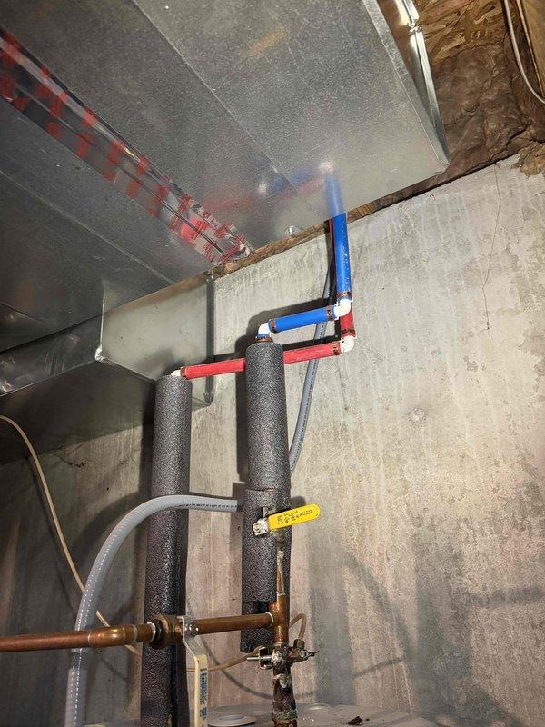 Completed replacement of water heater in basement. Installed new unit with proper PEX piping connections (red for hot water, blue for cold water) and added foam insulation on vertical pipes. Verified electrical connection to panel with appropriate circuit breakers (15A and 30A).