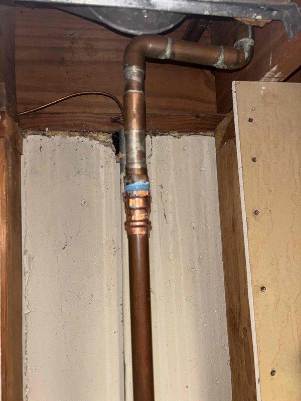 Responded to recall job #1292865 regarding water heater leak. Inspected copper pipe installation and connections in basement utility area. Found and repaired leaking joint at 90-degree elbow connection where previous sealant had failed, ensuring proper water flow and preventing further water damage.