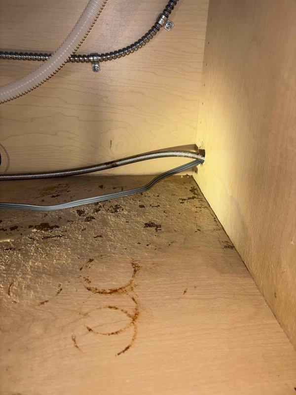 Replaced severely corroded garbage disposal unit at kitchen island sink that was leaking due to rust damage at the flange connection, causing water damage to the cabinet base. Performed additional inspection of reported leaking Kohler Veil Comfort Height toilet in master bathroom.