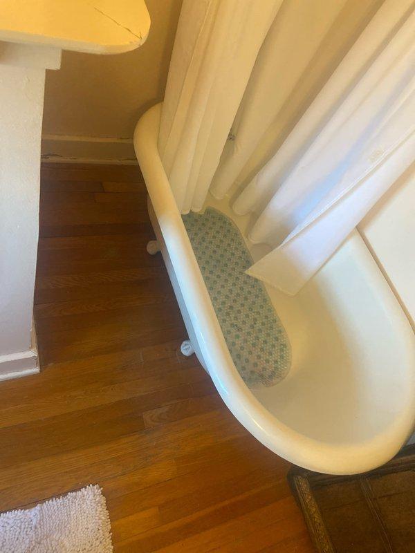 Conducted site assessment for bathroom remodel quote, including measuring clearance between existing radiator and toilet fixture (approximately 11 inches). Inspected current bathtub installation with curved design and documented existing plumbing fixtures to develop comprehensive remodeling estimate.