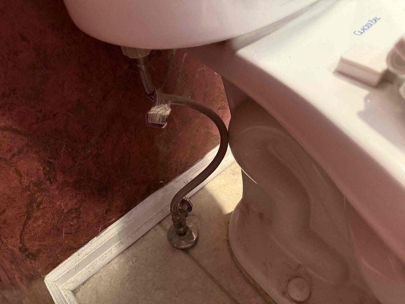 Diagnosed and serviced waste pump system affecting multiple toilets with incomplete flushing issues on both upper and lower levels. Inspected drain assemblies and water supply lines, finding sediment buildup and water staining that was causing restricted flow. Cleared blockages and restored proper waste water drainage functionality to all affected fixtures.