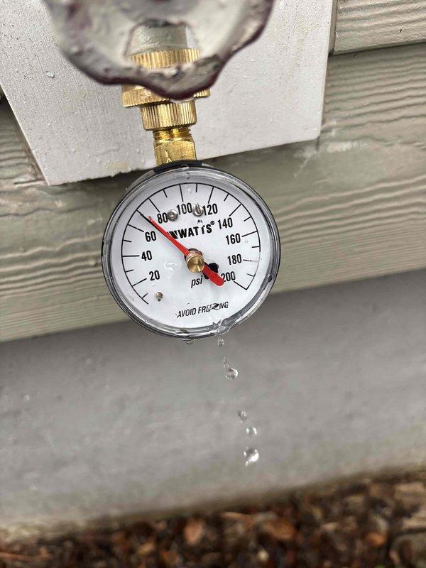 Responded to follow-up service call regarding reported water heater leak. Diagnostic inspection revealed water dripping from pressure relief valve. Pressure gauge testing showed system operating at approximately 80-100 PSI, exceeding recommended parameters. Installed pressure regulator to normalize system pressure and prevent further relief valve discharge.