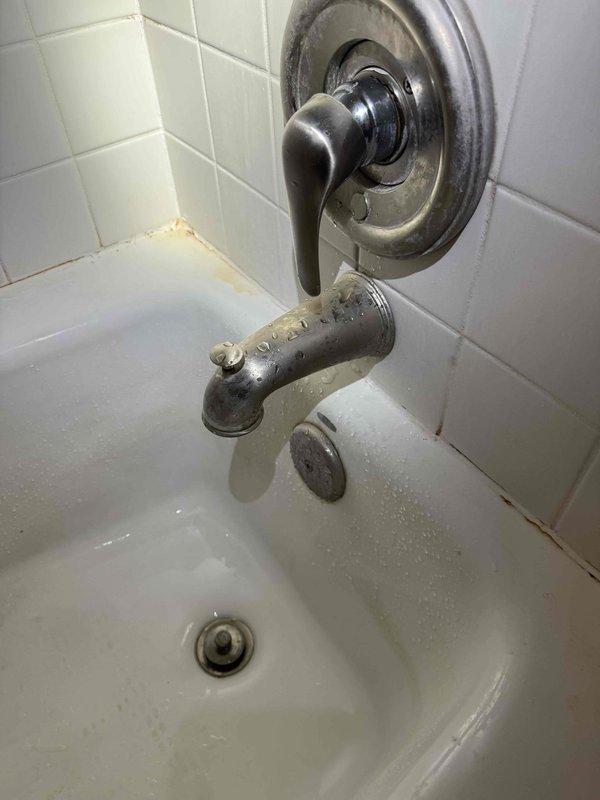 Responded to service call for leaking faucets in two bathrooms. Inspected both tub/shower fixtures which showed signs of aging with water spots and tarnishing on the metal components. Repaired the lever-style handles and spouts, addressing the leaks and ensuring proper function of the diverter mechanisms.