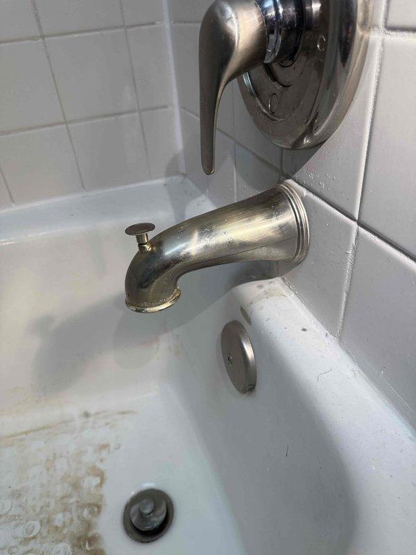Responded to service call for leaking faucets in two bathrooms. Inspected both tub/shower fixtures which showed signs of aging with water spots and tarnishing on the metal components. Repaired the lever-style handles and spouts, addressing the leaks and ensuring proper function of the diverter mechanisms.