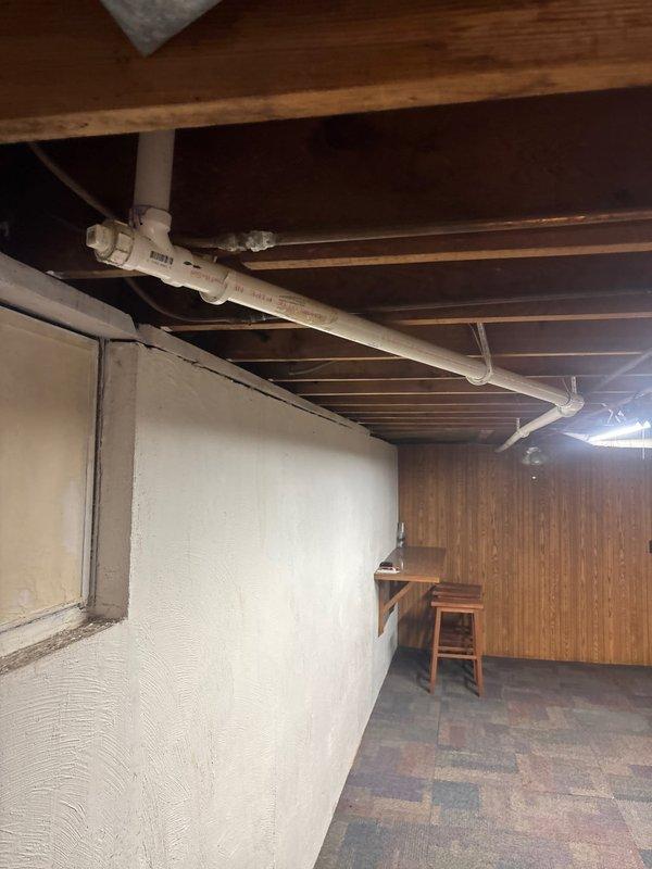 Responded to service call for a kitchen sink clog. Inspected the P-trap and drainage system, which required accessing basement plumbing. Cleared obstruction in the PVC drain line where it connects to the main waste stack. Successfully restored proper drainage function and verified system operation before completion.