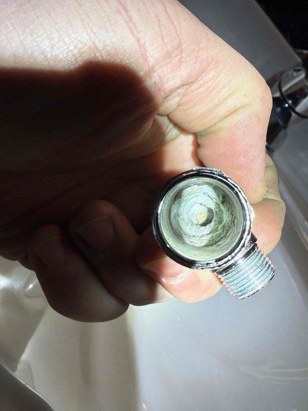 Replaced two deteriorated shut-off valves under sink in basement. Installed new chrome shut-off valves after removing significant mineral deposits from existing plumbing connections. Tested water flow and confirmed proper operation with no leaks.