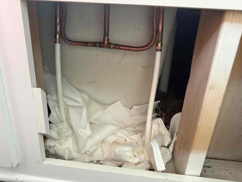 Completed installation of ball valve in residential plumbing system, involving copper supply lines and PVC piping. Successfully installed and tested new shut-off valves with red handles on both sides of the installation, providing improved water flow control for the homeowner.