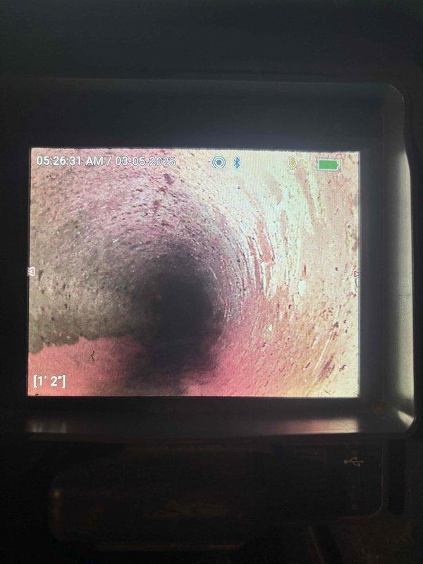 Responded to service call for a backed-up drain in laundry room. Performed camera inspection of sewer line, revealing mineral buildup and deposits along pipe walls. Cleared blockage and verified proper drainage function.