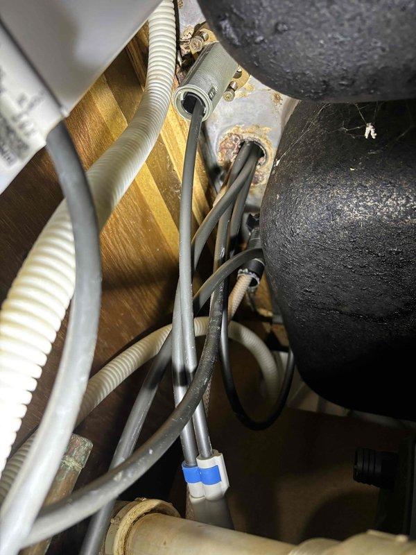 Responded to service call for leaking kitchen faucet. Upon inspection, found significant discoloration, rust stains, and mineral deposits on the PVC drain pipe assembly, particularly around the P-trap. Removed old faucet, installed new company-supplied replacement, and verified proper operation with no leaks.