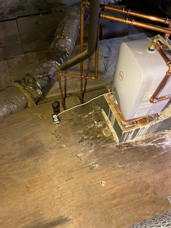 Conducted site evaluation for bathroom installation in unfinished basement area requiring concrete cutting for new plumbing lines. Inspected existing water heater and copper supply lines to determine integration points for proposed bathroom fixtures. Documented floor conditions showing significant cracking and water damage that will need addressing before installation proceeds.