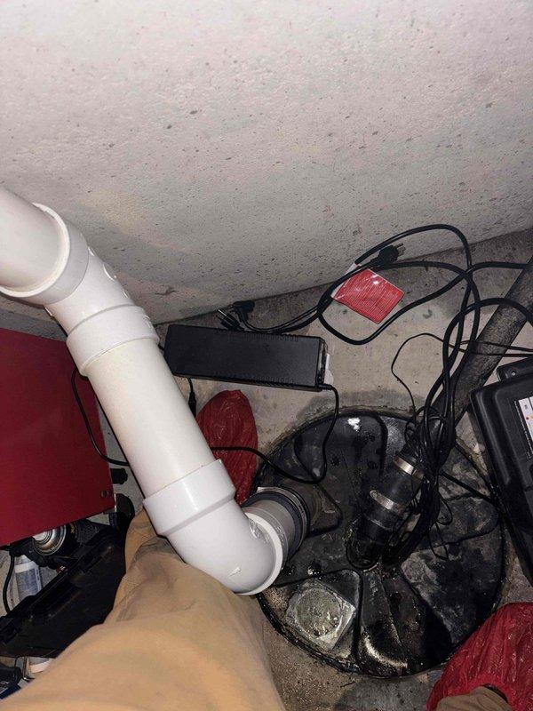 Successfully installed new sump pump in 20-year-old home's basement utility area. Replaced existing unit with upgraded model, ensuring proper electrical connections to control box with indicator light. Verified system functionality with water drainage through PVC piping.