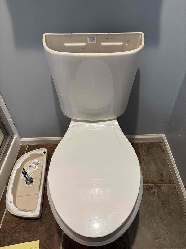 Diagnosed and repaired toilet water leak by removing the tank, replacing worn flapper and tank bolts, and installing new seals. Verified proper operation after reassembly with no signs of leakage at the base or tank connection.