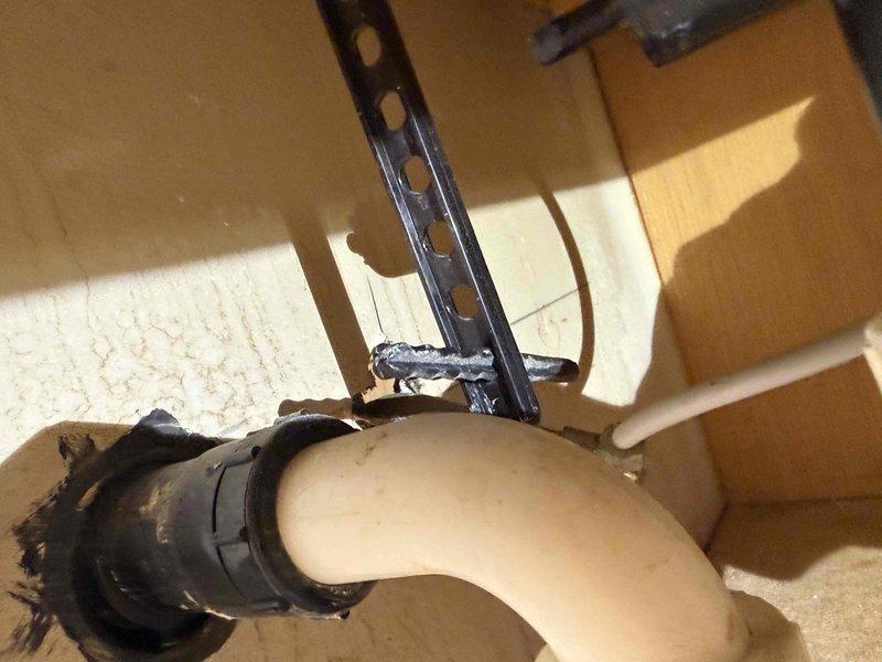 Responded to service call for bathroom sink leak causing cabinet wood damage. Upon inspection, discovered a cracked PVC drainage pipe at the connection point where the smaller fitting meets the main pipe body. Replaced damaged section with new PVC pipe and fittings, properly sealed all connections, and verified system integrity with leak test.