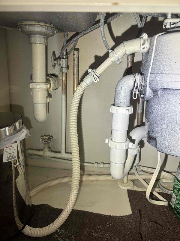 Removed and replaced customer's shower head that was stuck and required professional assistance. Inspected under-sink plumbing including P-trap, drain pipes, and disposal unit to ensure proper function. All fixtures were tested and confirmed to be operating correctly with no leaks detected.