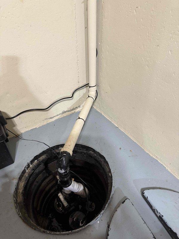 Replaced faulty sump pump in basement due to non-functioning float. Installed new submersible pump with proper connection to existing PVC discharge pipe and verified electrical connections were secure and operational.