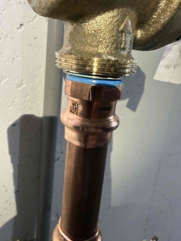 Responded to recall job regarding a leaking pressure valve in basement. Upon inspection, found and replaced the defective brass pressure valve that was leaking at the copper pipe connection. Installed new valve with proper blue gasket seal at the threaded connection point and verified system operation with no leaks present.