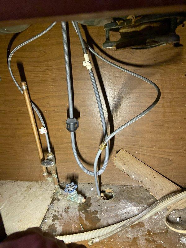 Performed assessment of kitchen sink area in preparation for upcoming demolition work. Disconnected dual-basin sink faucet as requested, ensuring water supply lines were properly secured. Verified all plumbing connections and documented current installation configuration with photos for reference during future renovation work.