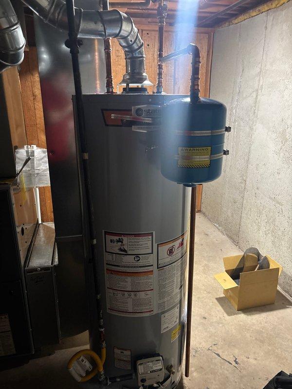Successfully installed a 40-gallon gas water heater with thermal expansion tank in basement utility area. Connected unit to existing plumbing and gas lines using appropriate fittings and safety mechanisms. Added 1/4 turn stop for humidifier and verified all connections are secure with proper labeling in place.