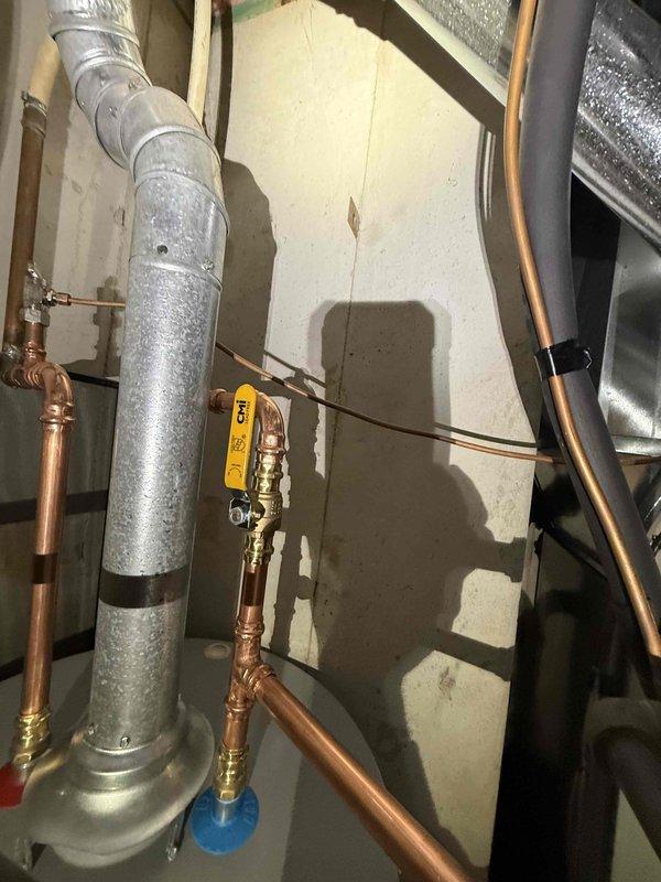 Installed new 50 gallon Bradford White gas water heater with Defender safety system, replacing corroded unit. Completed all necessary copper pipe connections and installed proper venting. Verified operation of unit and confirmed no leaks at all connection points.
