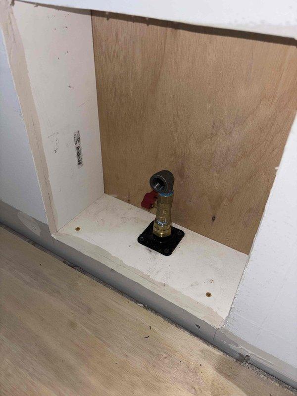 Successfully repaired a 1" gas line segment (approximately 5' section) in a recessed wall cavity. Installed new brass valve fixture with secure mounting to the access panel, ensuring proper connection to the building's gas supply system that runs through the basement ceiling joists alongside existing PEX water lines.