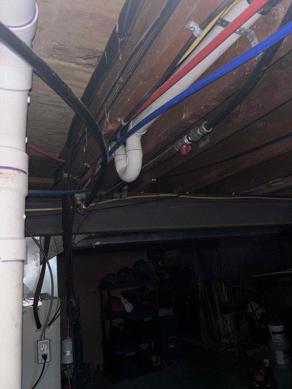 Successfully repaired a 1" gas line segment (approximately 5' section) in a recessed wall cavity. Installed new brass valve fixture with secure mounting to the access panel, ensuring proper connection to the building's gas supply system that runs through the basement ceiling joists alongside existing PEX water lines.