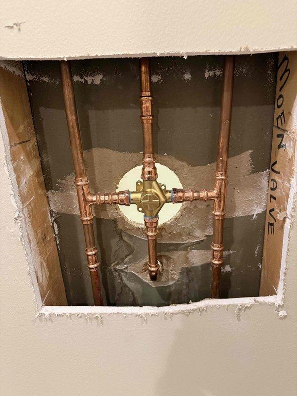Successfully installed customer-supplied shower valve, requiring removal of drywall section to access plumbing infrastructure. Completed proper connection of valve assembly to existing copper supply lines and verified functionality before completion.