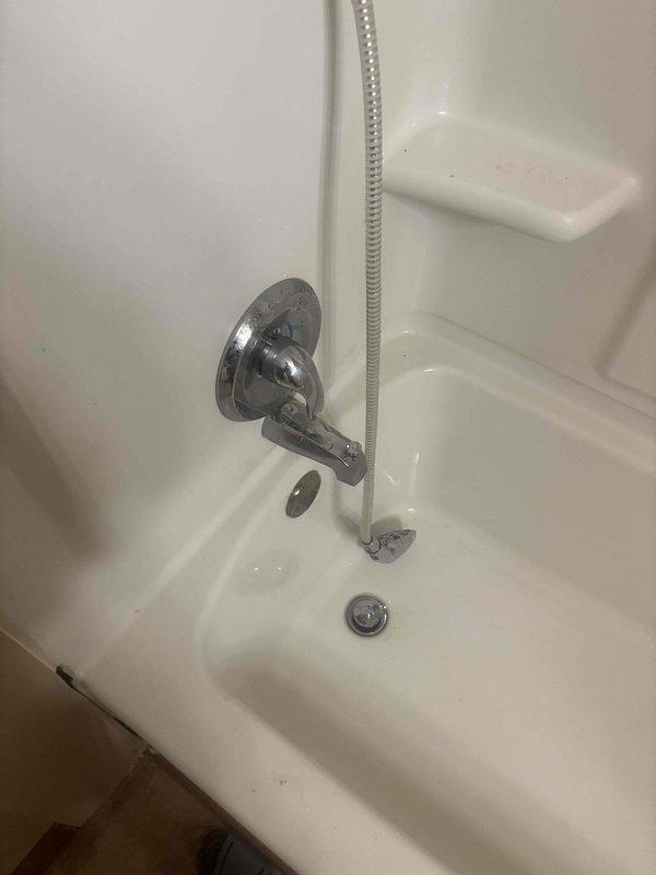 Responded to a service call for a bathtub spout replacement in the hallway bathroom. Upon inspection, found the existing chrome diverter valve and shower head connection showing signs of wear. Successfully removed the old fixture and installed a new tub spout, ensuring proper sealing at connection points and verifying proper water flow operation.