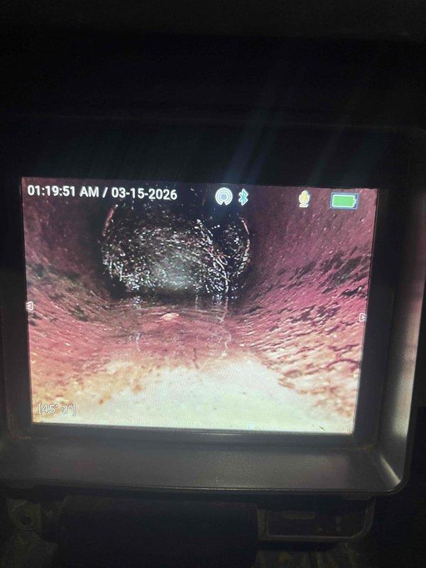 Responded to main line backup issue in garage area. Performed camera inspection of the drain line which revealed interior pipe conditions requiring cleaning. Successfully cleared standing water from floor drain and surrounding concrete area, resolving the backup problem.