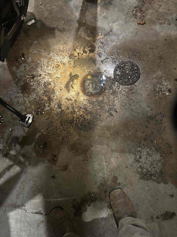 Responded to main line backup issue in garage area. Performed camera inspection of the drain line which revealed interior pipe conditions requiring cleaning. Successfully cleared standing water from floor drain and surrounding concrete area, resolving the backup problem.