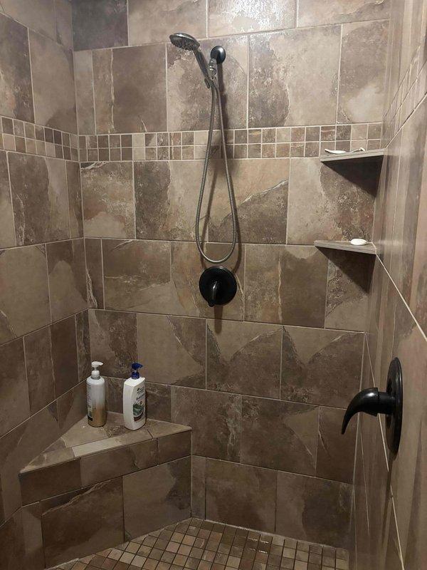 Responded to emergency service call for broken shower handle that required whole-home water shutoff. Successfully replaced damaged shower control handle in tile-surround bathroom with decorative mosaic accent band. Restored proper function to the shower fixture and educated customer on location of shut-off valve for future reference.