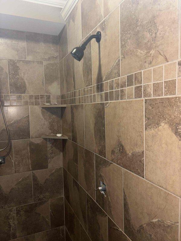 Responded to emergency service call for broken shower handle that required whole-home water shutoff. Successfully replaced damaged shower control handle in tile-surround bathroom with decorative mosaic accent band. Restored proper function to the shower fixture and educated customer on location of shut-off valve for future reference.