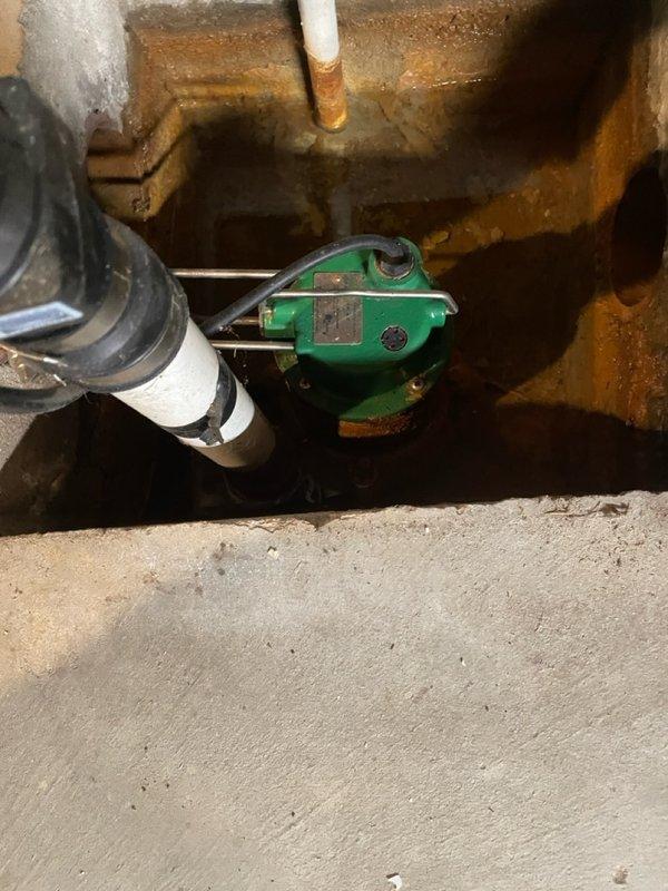 Performed comprehensive inspection and servicing of existing basement sump pump to ensure proper functionality. Checked valve assembly and plumbing connections, noting significant corrosion on metal components requiring attention. System is now operating correctly with all components verified for optimal performance.