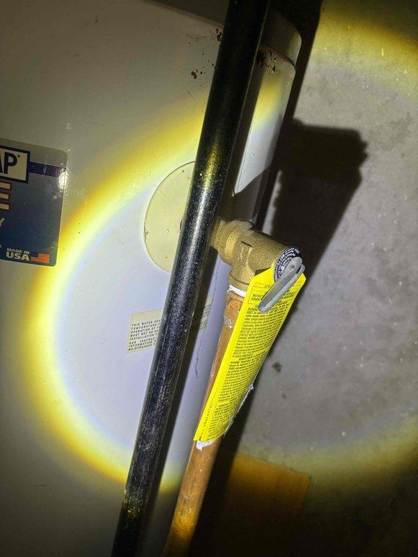 Conducted estimate for water heater replacement. Existing unit shows significant age with corroded connections and pipe fittings. Observed extensive rust on copper piping at U-bend and deterioration of shutoff valve assembly. Recommended complete replacement of water heater and associated plumbing components due to advanced wear and corrosion.