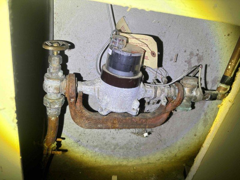 Conducted estimate for water heater replacement. Existing unit shows significant age with corroded connections and pipe fittings. Observed extensive rust on copper piping at U-bend and deterioration of shutoff valve assembly. Recommended complete replacement of water heater and associated plumbing components due to advanced wear and corrosion.