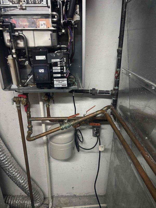 Inspected Rinnai hydronic furnace system with reported vibration issues. Determined unit was incorrectly installed with improper piping configuration and lacks manufacturer registration for warranty coverage. Documented installation deficiencies including substandard copper pipe connections and improper valve placement that are contributing to operational noise.