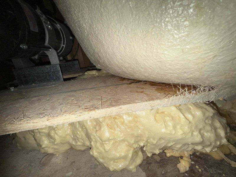 Responded to a reported leak from master bathroom affecting porch light fixture. Inspection of the structural cavity revealed moisture damage to wooden joists. Applied spray foam insulation to seal gaps between structural elements and around pipes to prevent further water intrusion.