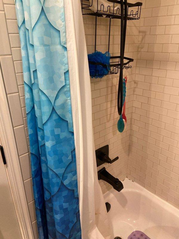 Conducted on-site evaluation for conversion of existing bathtub to walk-in shower. Inspected current bathroom configuration featuring white subway tile walls and standard bathtub with black fixtures. Documented measurements and existing plumbing connection points to prepare comprehensive estimate for complete tub-to-shower conversion.