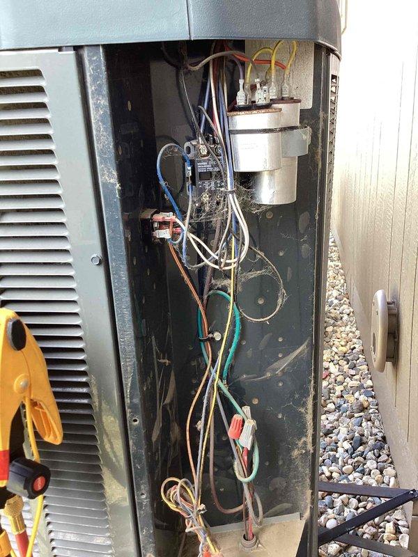 Performed scheduled maintenance on a side-mounted cooling unit. Conducted electrical diagnostic testing using a Klein Tools CL390 clamp meter, measuring amperage draw at 1.666A. Inspected interior electrical components including capacitors, circuit board, and terminal connections, noting some dust accumulation and cobwebs on the wiring harness. All systems verified operational with readings within manufacturer specifications.