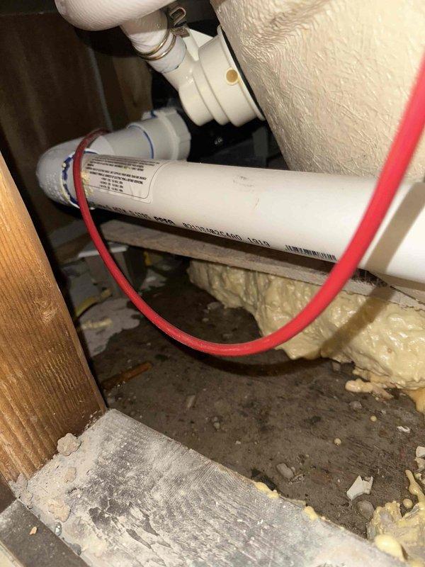Responded to customer callback regarding persistent water leak manifesting at front porch light fixture. Inspection revealed improper application of expanding foam insulation around copper pipes, which failed to seal the leak and caused water to travel through wall cavity to exterior light. Removed excessive foam, properly sealed pipe connections, and verified system integrity with pressure test to resolve the issue.
