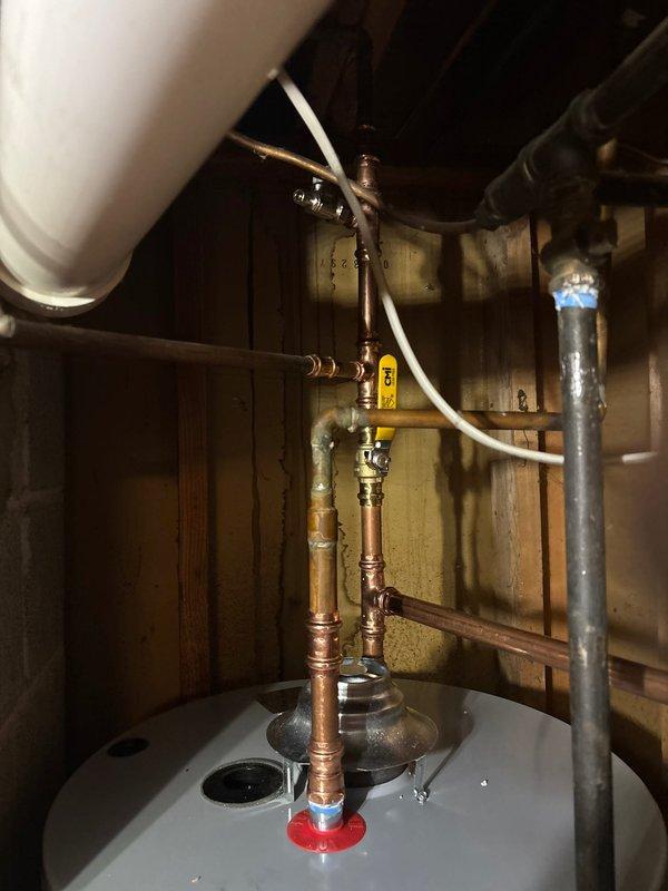 Successfully installed a 50-gallon natural gas water heater with proper gas line connections and safety valves. Mounted a code-compliant expansion tank with secure wall strapping to prevent movement. Completed all copper piping connections with professional soldering technique, ensuring proper ventilation and leak-free operation.